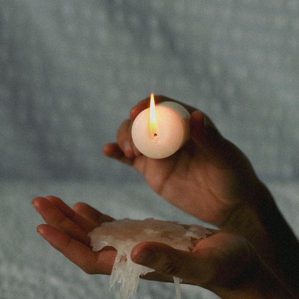Close-up of hands in a meditative gesture.